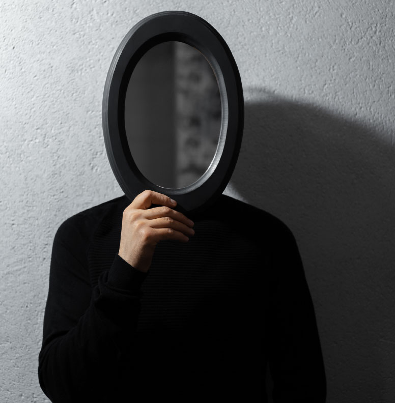 person with a mirror in front of their face